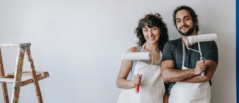 Homme et femme peignant un mur